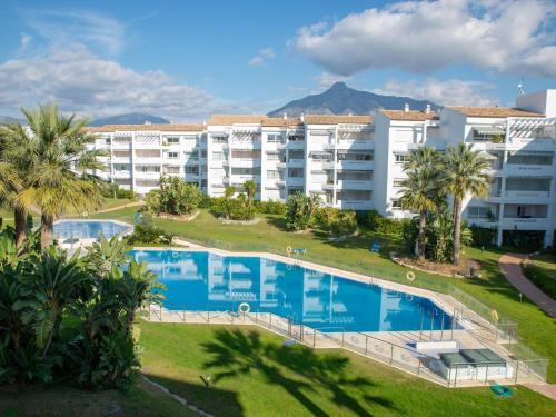 an aerial view of a hotel with a large swimming pool at VACATION MARBELLA I Beachfront Quiet Apt with Private Beach Access in Marbella