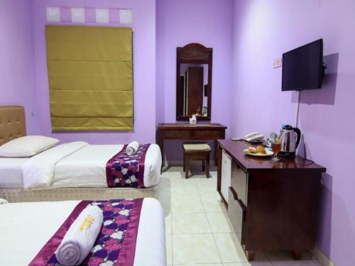 Ένα ή περισσότερα κρεβάτια σε δωμάτιο στο Hotel Signature Mandala Kencana