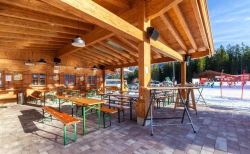 a pavilion with tables and chairs and a playground at Alpengasthof Götschenalm in Bischofswiesen
