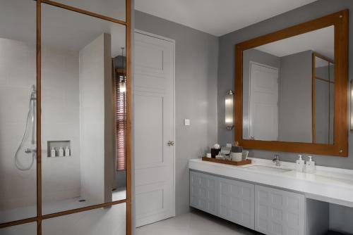 a bathroom with a sink and a mirror at Sirinati Khao Kho in Khao Kho