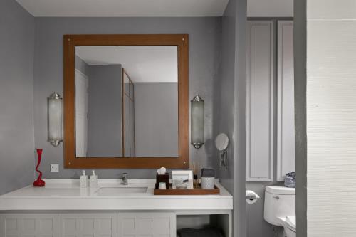 a bathroom with a sink and a mirror at Sirinati Khao Kho in Khao Kho