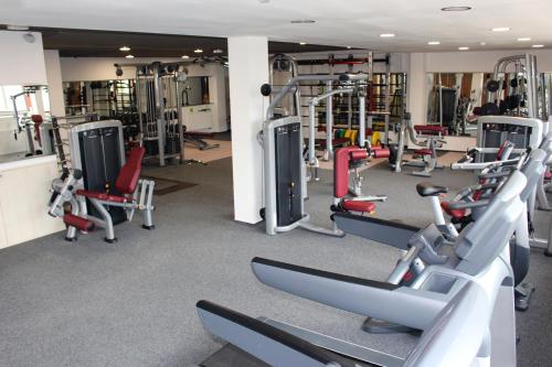 a gym with lots of treadmills and machines at Apartman Lucid C207 in Smokovce