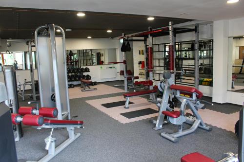 a gym with several treadmills and machines at Apartman Lucid C207 in Smokovce