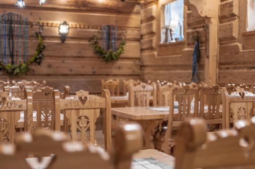 a room with tables and chairs in a building at Willa Bór in Zakopane