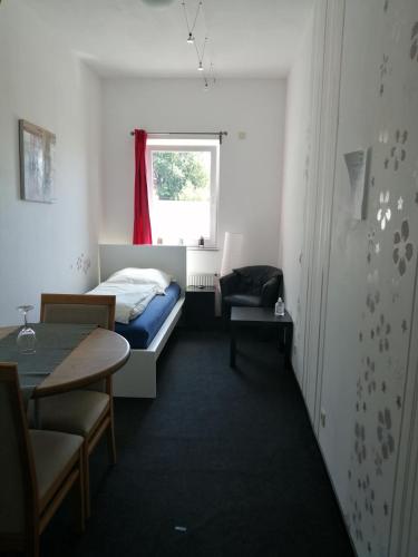 a room with a bed and a table and a window at B&B V.K. PGmbH in Saint-Vith