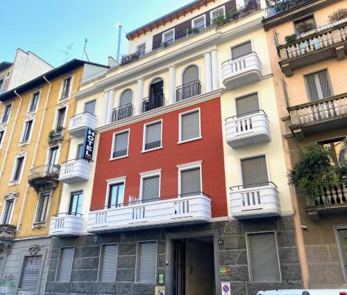 a building with white balconies on the side of it at Golden Milano Hotel in Milan