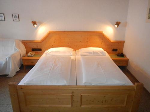 a bedroom with two beds and two night stands at Haus Garni Luggi Leitner in Mittelberg