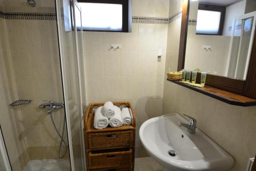a bathroom with a sink and a shower and a toilet at Georgio's V Chalet Kalavrita in Kalavrita