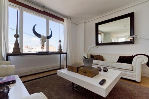 a living room with a cow head on the window at Valencia Luxury - Boutique Center in Valencia