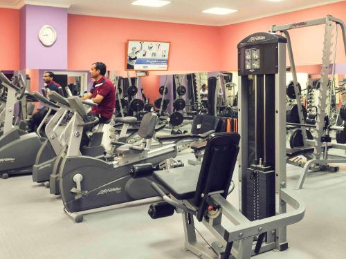 a gym with several people exercising on tread machines at Mercure Ismailia Forsan Island in Ismailia