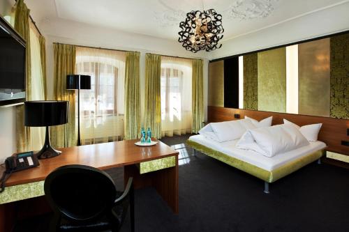 a bedroom with a bed and a desk and a desk at Schloss zu Hopferau in Hopferau