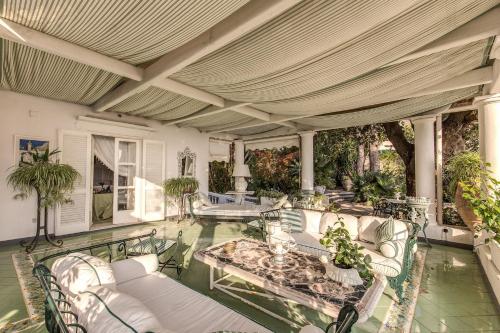 an outdoor living room with a table and chairs at Villa Prestige '50 in Capri