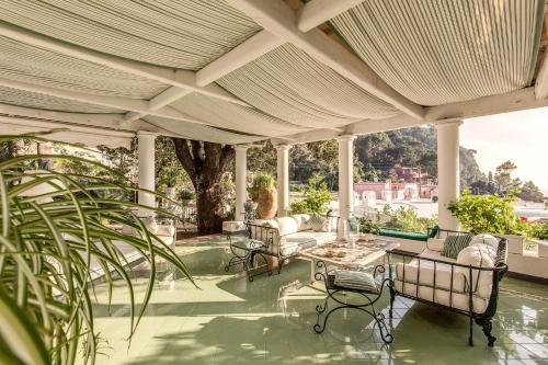 an outdoor patio with chairs and a table on a building at Villa Prestige '50 in Capri