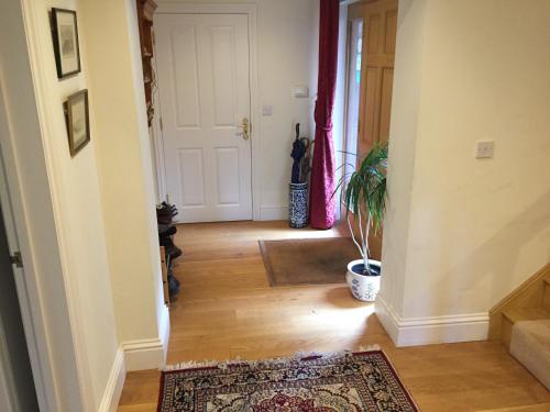 a hallway with a door and a rug at Riverdown in Topsham