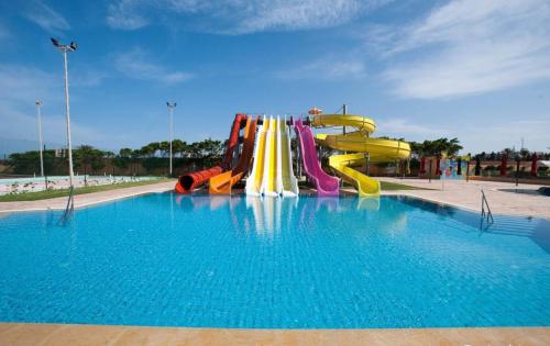 a pool with a water slide in a park at Hotel Nour Palace Resort & Thalasso Mahdia in Mahdia