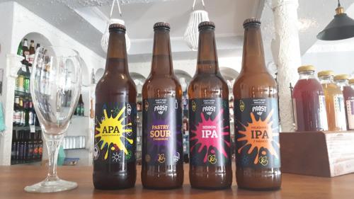 a group of beer bottles on a table with a glass at Zajazd pod Lwem in Trzebnica