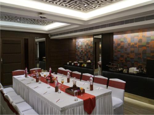 a dining room with a table and chairs and a restaurant at The Sonnet Jamshedpur in Jamshedpur