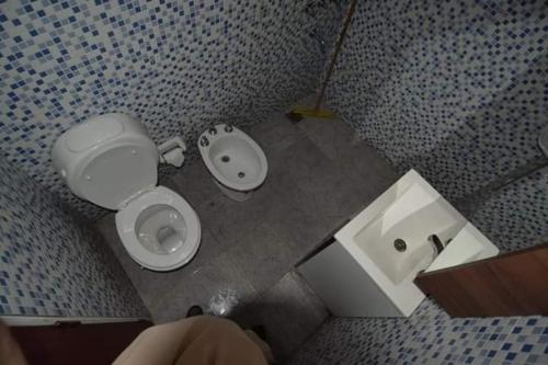 a bathroom with a toilet and a bidet and a sink at Susurro de Montaña (TIERRA SANTA) in San Lorenzo