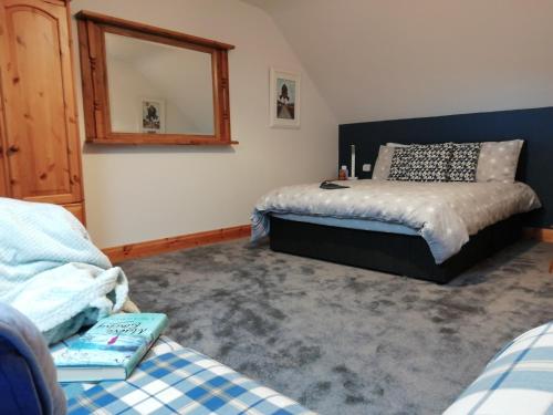 a bedroom with two beds and a mirror at The Hill House Meenaleck with Sunrise views in Crolly