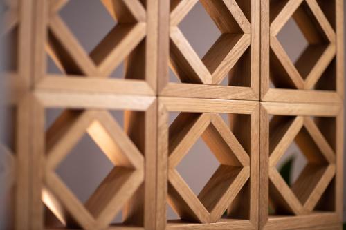 a wooden door with a lattice pattern on it at Kouros Exclusive Hotel & Suites - Adults Only in Faliraki