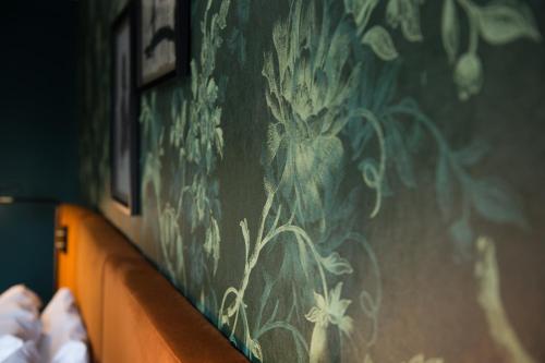 a wall with a painting of flowers on it at Hotel Du Vin Stratford in Stratford-upon-Avon