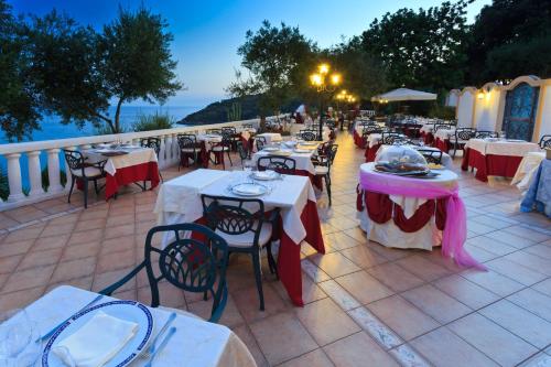 a row of tables and chairs on a patio at Grand Hotel Le Rocce in Gaeta