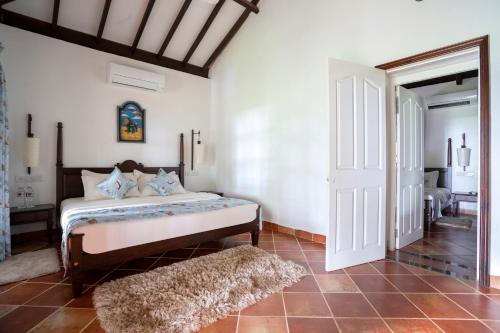 a bedroom with a bed in a room at Montego Bay Beach Village - Morjim in Morjim