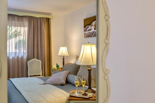 a hotel room with a bed and a mirror at Agrimia Holiday Apartments in Plataniás