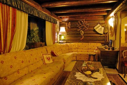 a living room with a couch and a table at Hotel Edelweiss & SPA in Cesana Torinese