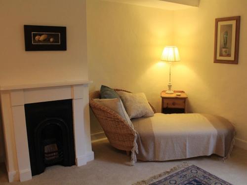 a living room with a bed and a fireplace at Church Farmhouse B & B in Kennett