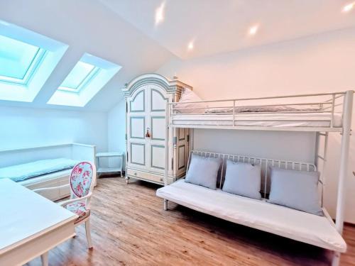 a bedroom with two bunk beds and a couch at Marie Antoinette in Schwandorf in Bayern