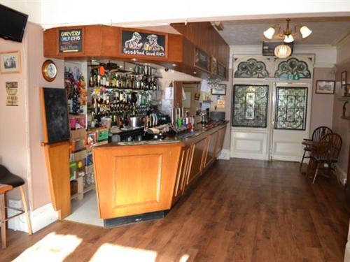 a kitchen with a bar in a room at The Sandrock Lynton in Lynton