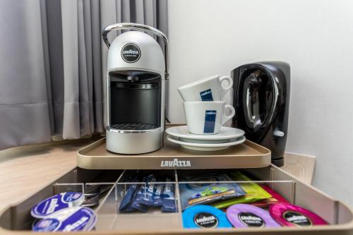 a coffee maker sitting on top of a shelf at Hotel de Rousch - 4 sterren Superieur in Heerlen
