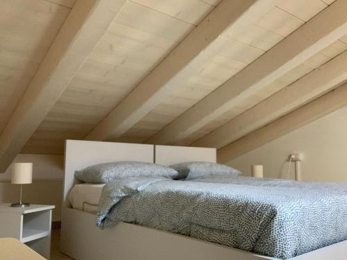 a bedroom with a bed with blue blankets and pillows at Villa Angela in Prosto di Piuro