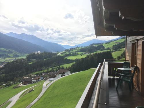 a balcony with a view of a green valley at Schröckhof in Stuhlfelden