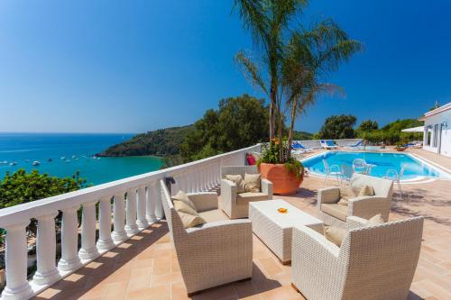 a balcony with chairs and a swimming pool at Grand Hotel Le Rocce in Gaeta