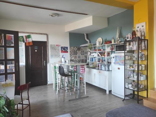 a kitchen with a table and chairs and a refrigerator at HostelChe Guest House in Smederevo