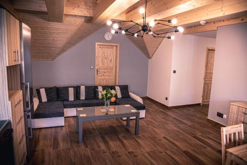 a living room with a couch and a table at Red Pine Apartments in Vlachovice