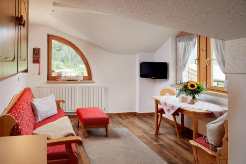 a living room with a couch and a table at Hotel Central - das kleine Boutique Hotel am Achensee in Pertisau
