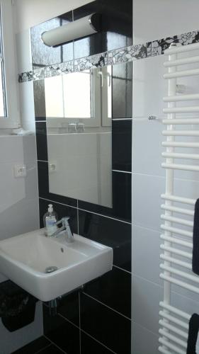 a bathroom with a sink and a mirror at Vila Patricie in Luhačovice