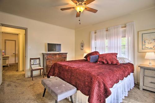 a bedroom with a bed and a ceiling fan at Ranch-Style Cottage - 2 Miles to Philbrook Museum! in Tulsa