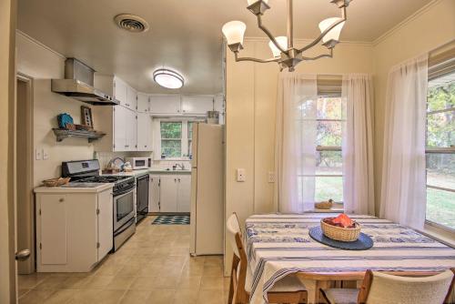 a kitchen and dining room with a table and chairs at Ranch-Style Cottage - 2 Miles to Philbrook Museum! in Tulsa
