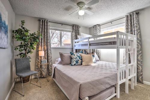 a bedroom with a white bunk bed and a chair at Duplex with Private Yard 3 Mi to Downtown Loveland! in Loveland