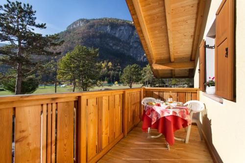 a wooden balcony with a table and chairs on it at Casa Nonni in Molveno