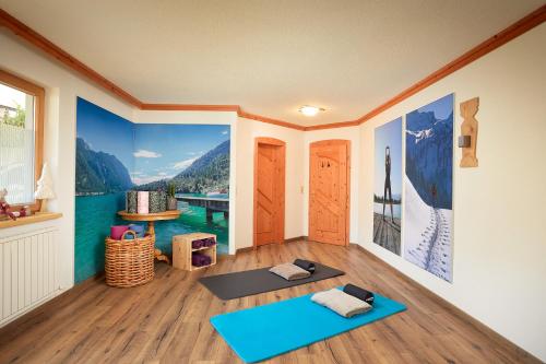 a room with a yoga room with a view of a mountain at Hotel Central - das kleine Boutique Hotel am Achensee in Pertisau