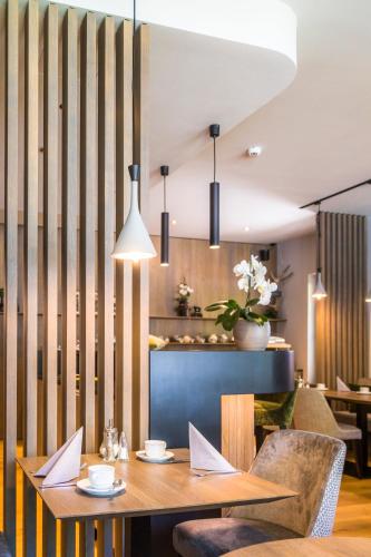 a dining room with a wooden table and chairs at Pension Appartements Gabriele in Bad Gastein