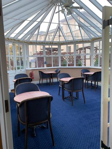 a large room with tables, chairs, and tables in it at Yelf's Hotel in Ryde