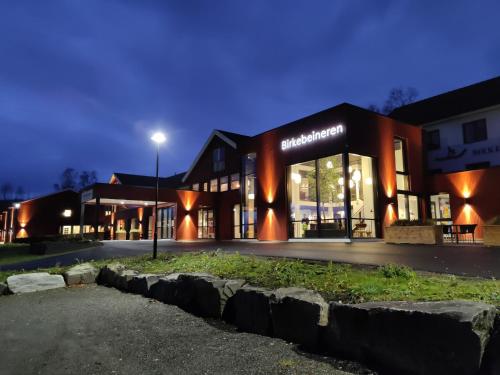 a building with a street light in front of it at Birkebeineren Hotel & Apartments in Lillehammer