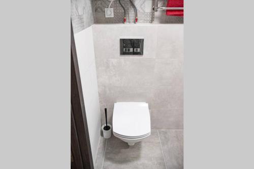 a bathroom with a white toilet in a room at Квартира по ул. Козацкая 1/2 in Cherkasy