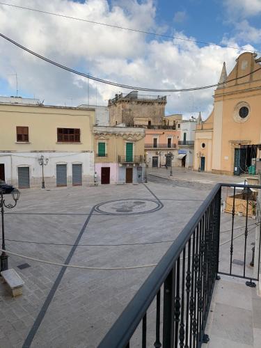 an empty parking lot in a town with buildings at Piazza del Popolo in San Pietro Vernotico